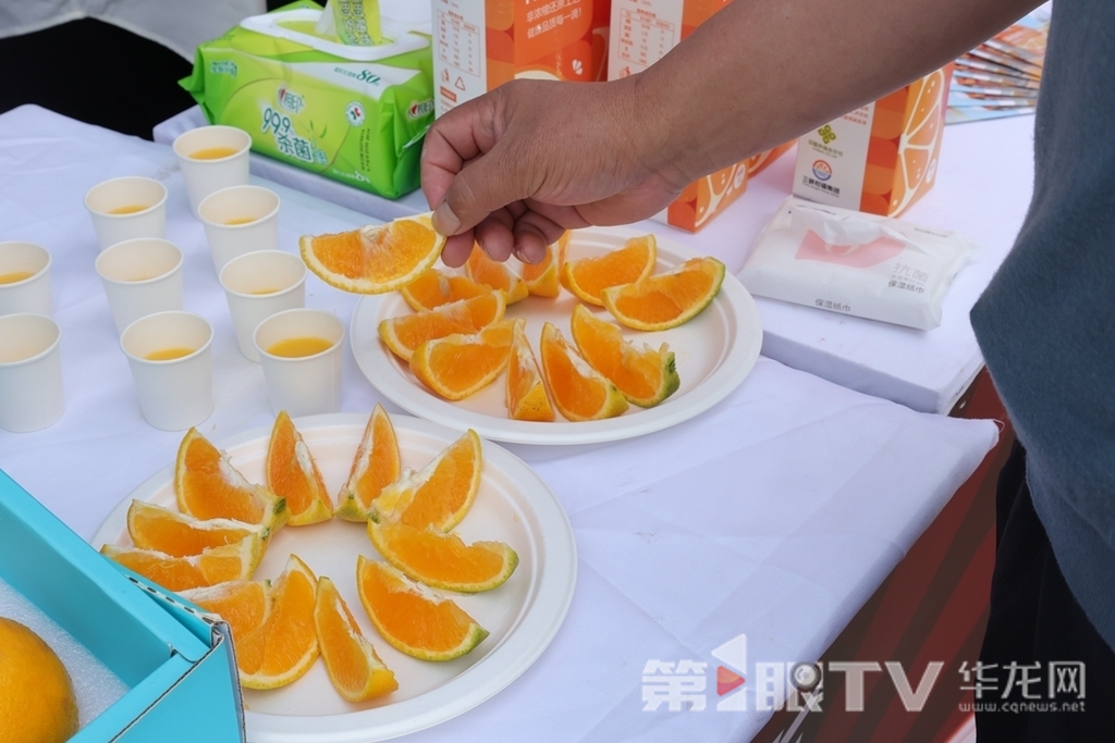 3 本地居民拿起橙子品嘗。第1眼TV-華龍網 董靜 攝