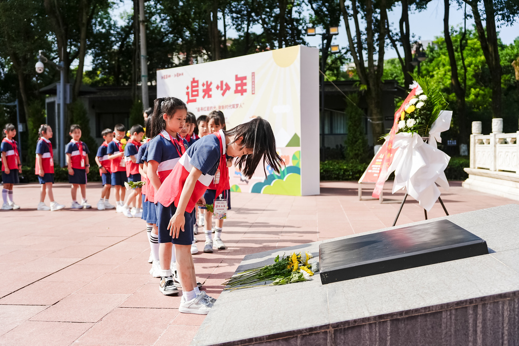 “追光少年”们敬献鲜花。红岩研学实践教育基地供图