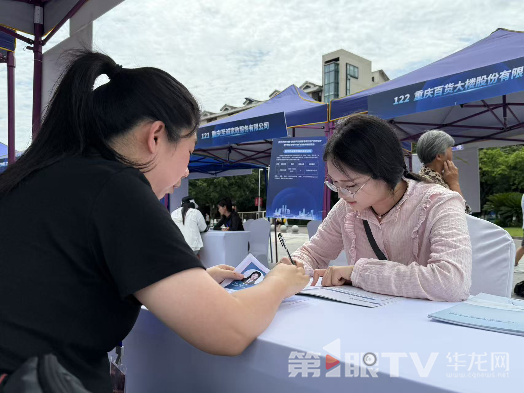 求职者正在填写求职报名表。第1眼TV-华龙网记者 谢鹏飞 摄