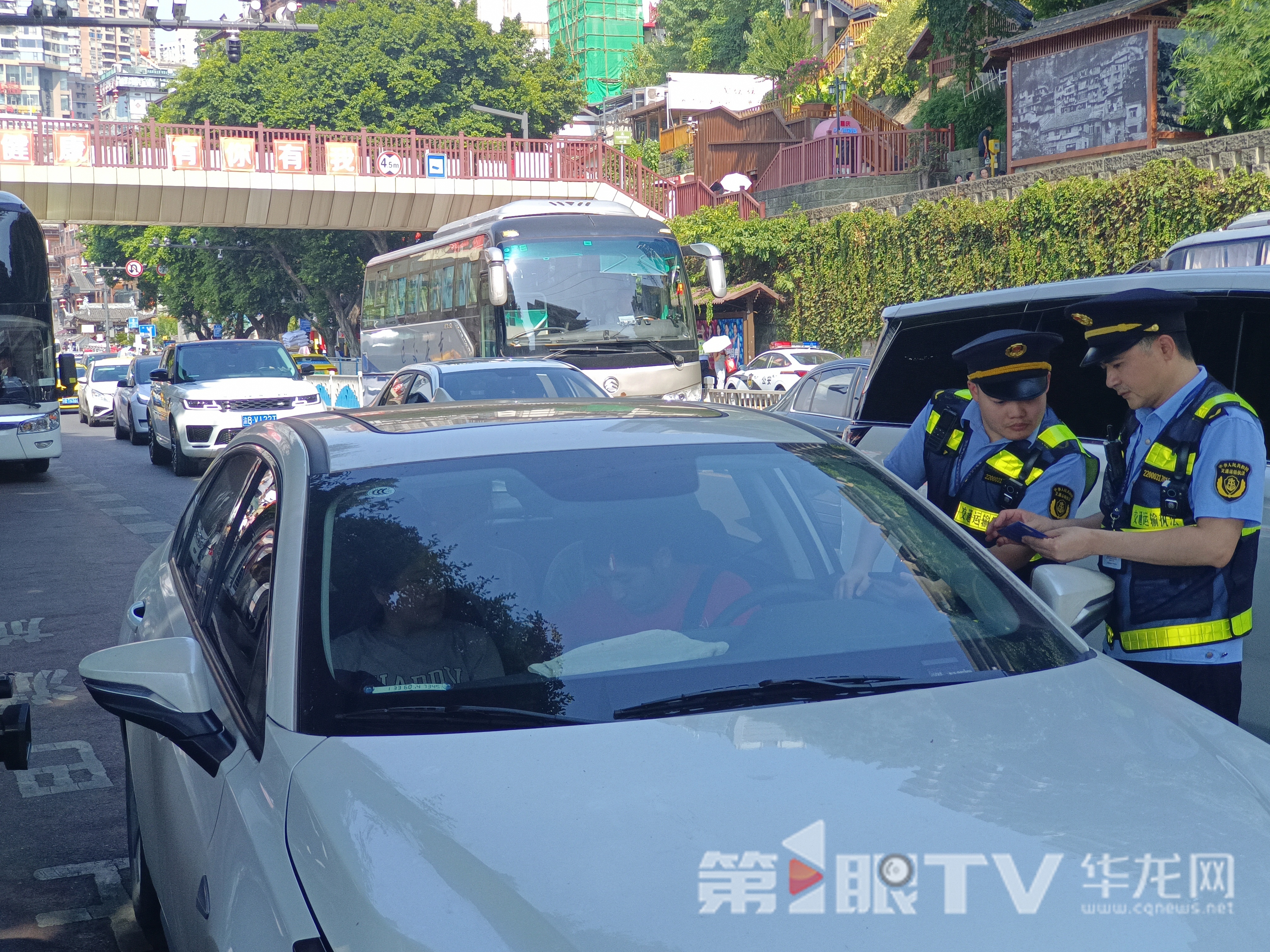 洪崖洞景区外,执法队员对网约车进行例行检查。第1眼TV-华龙网记者 刘艳 摄