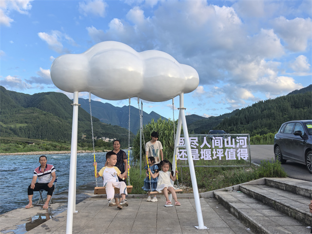 居民在長灘河邊乘涼。堰坪鎮供圖
