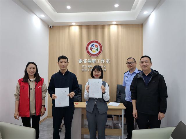 社區(qū)民警、網(wǎng)格員成功調(diào)解謝先生與李女士矛盾糾紛，雙方握手言和。通訊員 王軒 攝